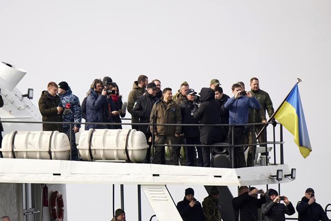In this handout photo provided by the Ukrainian Presidential Press Office, Ukrainian President Volodymyr Zelenskyy, center-top, stands on boat during his visit to the Ukrainian coast guard, in Mariupol, Donetsk region, eastern Ukraine, Thursday, Feb. 17, 2022. U.S. Secretary of State Antony Blinken told ABC News that Russian President Vladimir Putin
