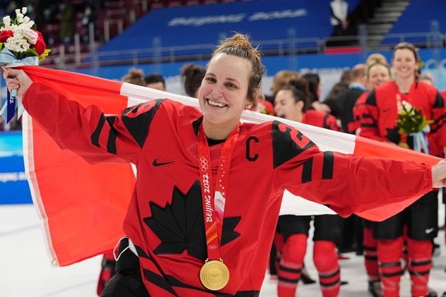 Team Canada forward Marie-Philip Poulin (29) celebrates with her gold medal after defeating the United States in women's hockey gold medal game action at the 2022 Winter Olympics in Beijing on Thursday, Feb. 17, 2022. THE CANADIAN PRESS/Ryan Remiorz