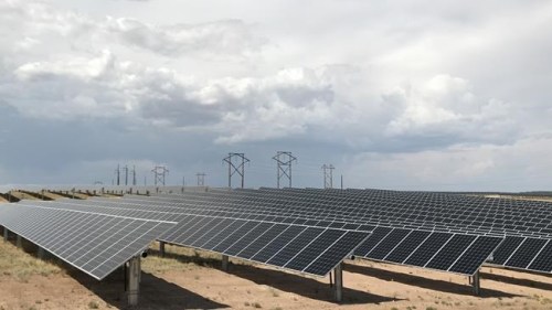 FILE - This June 15, 2021 photo shows a Public Service Co. of New Mexico solar farm west of Rio Rancho, N.M. The utility in sun-drenched New Mexico is struggling to get enough solar-generated electricity as it prepares to shut down a coal-fired power plant amid supply chain disruptions, one of the problems threatening to delay or cancel projects around the world amid pressure to reduce carbon emissions and tackle climate change. Public Service Co. of New Mexico initially proposed replacing the lost capacity with a mix of natural gas, solar and battery storage. The Public Regulation Commission instead opted for solar and storage to make up some of the difference after environmentalists pushed back on gas. (AP Photo/Susan Montoya Bryan, File)