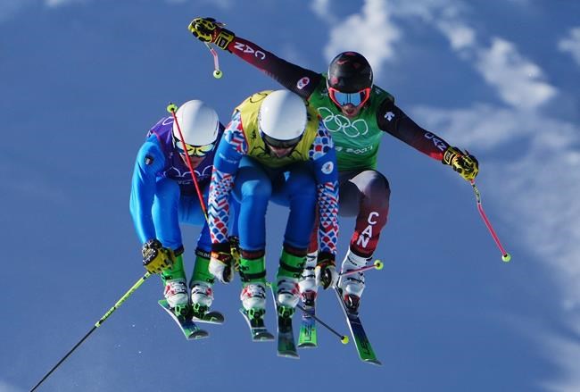 Italy's Simone Deromedis, left to right, Russian Olympic Committee's Sergey Ridzik and Canada's Brady Leman compete in the freestyle men's ski cross semifinals during the Beijing Winter Olympic Games, in Zhangjiakou, China, Friday, Feb. 18, 2022. THE CANADIAN PRESS/Sean Kilpatrick