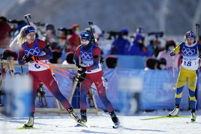 Tiril Eckhoff of Norway (6) and Marte Olsbu Roeiseland of Norway (2) arrive at the shooting range during the women's 12.5-kilometer mass start biathlon at the 2022 Winter Olympics, Friday, Feb. 18, 2022, in Zhangjiakou, China. (AP Photo/Frank Augstein)