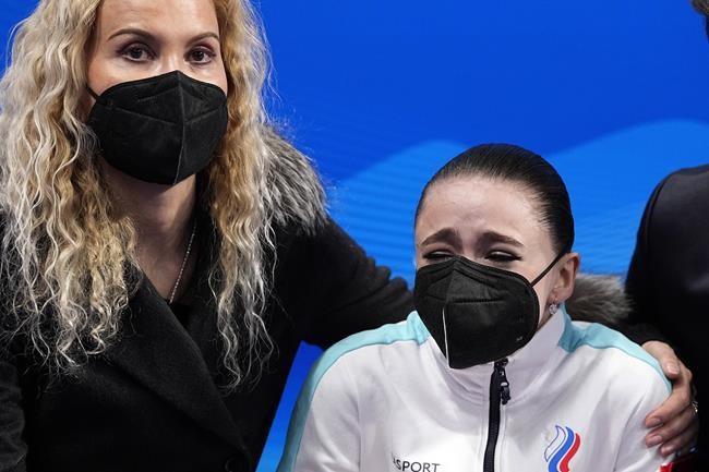 Kamila Valieva, of the Russian Olympic Committee, is embraced by her coach Eteri Tutberidze after competing in the women's free skate program during the figure skating competition at the 2022 Winter Olympics, Thursday, Feb. 17, 2022, in Beijing. (AP Photo/David J. Phillip)