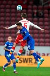 Mainz's Anton Stach, background centre and Leverkusen's Patrik Schick vie for the ball, during the German Bundesliga soccer match between Mainz and Bayer Leverkusen, in Mainz, Germany, Friday, Feb. 18, 2022. (Thomas Frey/dpa via AP)