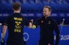 Sweden's Rasmus Wranaa, left and Sweden's Niklas Edin encourage each other during the men's curling final match between Britain and Sweden at the Beijing Winter Olympics Saturday, Feb. 19, 2022, in Beijing. (AP Photo/Brynn Anderson)