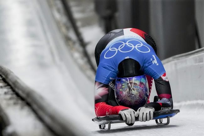 Mirela Rahneva, of Canada, looks down after the women's skeleton run 4 at the 2022 Winter Olympics, Saturday, Feb. 12, 2022, in the Yanqing district of Beijing. THE CANADIAN PRESS/AP-Pavel Golovkin