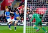 Southampton's Shane Long, top, scores during the English Premier League soccer match between Southampton and Everton at St Mary's, Southampton, England, Saturday Feb. 19, 2022. (Andrew Matthews/PA via AP)