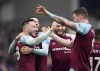Burnley's Josh Brownhill, left, celebrates scoring during the English Premier League soccer match between Brighton & Hove Albion and Burnley at the AMEX Stadium, Brighton, England, Saturday Feb. 19, 2022. (Adam Davy/PA via AP)