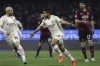 AC Milan's Junior Messias, right, celebrates with his teammate Theo Hernandez after scoring his side's opening goal during the Serie A soccer match between Salernitana and AC Milan, at the Arechi stadium in Salerno, Italy, Saturday, Feb. 19, 2022. (Alessandro Garofalo/LaPresse via AP)