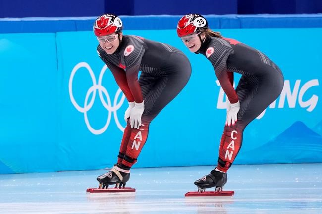 Kim Boutin (right) and Courtney Sarault of Canada smile after skating in the women's 1,500-metre short-track speedskating