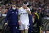 Leeds United's Robin Koch leaves the field with medics during the English Premier League soccer match between Leeds United and Manchester United, at Elland Road Stadium in Leeds, England, Sunday, Feb. 20, 2022. (AP Photo/Jon Super)