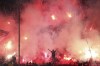 FILE - PAOK fans light flares during a Greek Soccer League match between PAOK and AEK Athens at Toumba stadium in the northern Greek city of Thessaloniki, on Sunday, Sept. 23, 2018. Soccer supporters' clubs will be suspended in Greece for five months as part of a crackdown announced Monday, Feb. 21, 2022, triggered by the murder of a 19-year-old who was stabbed and beaten to death by soccer hooligans in the northern city of Thessaloniki. (AP Photo/Giannis Papanikos, File)