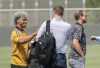 New York Mets' Francisco Lindor, left, and Los Angeles Dodgers' Max Scherzer, right, arrive at Roger Dean Stadium in Jupiter, Fla., for baseball labor negotiations, Tuesday, Feb. 22, 2022. Person at center is unidentified. (Greg Lovett/The Palm Beach Post via AP)