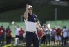 FILE - United States' Zach Johnson points to fans after winning a singles match at the Ryder Cup golf tournament Sunday, Oct. 2, 2016, at Hazeltine National Golf Club in Chaska, Minn. Two-time major champion Zach Johnson is taking over as Ryder Cup captain, leading an American side trying to end 30 years without a victory on European soil. Three people with knowledge of the decision confirmed the move to The Associated Press on condition of anonymity because the PGA of America has yet to announce Johnson’s selection. (AP Photo/David J. Phillip, File)
