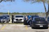 New York Mets pitcher Max Scherzer gets out of his car as he arrives for baseball labor talks at Roger Dean Stadium in Jupiter, Fla., Wednesday, Feb. 23, 2022. At far left is Major League Baseball Players Association executive director Tony Clark. (AP Photo/Ron Blum)