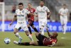 Dudu of Brazil's Palmeiras, left, and Thiago Heleno of Brazil's Athletico Paranaense battle for the ball during the Recopa Sudamericana final first leg soccer match in Curitiba, Brazil, Wednesday, Feb. 23, 2022. (AP Photo/Liamara Polli)