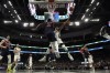 Milwaukee Bucks' Giannis Antetokounmpo shoots past Philadelphia 76ers' Joel Embiid during the second half of an NBA basketball game Thursday, Feb. 17, 2022, in Milwaukee. The 76ers won 123-120. (AP Photo/Morry Gash)