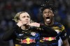 Leipzig's Emil Forsberg, left, celebrates after scoring his side's third goal during the Europa League Play-off, second leg, soccer match between Real Sociedad and Leipzig at the Reale Arena stadium in San Sebastian, Spain, Thursday, Feb. 24, 2022. (AP Photo/Alvaro Barrientos)