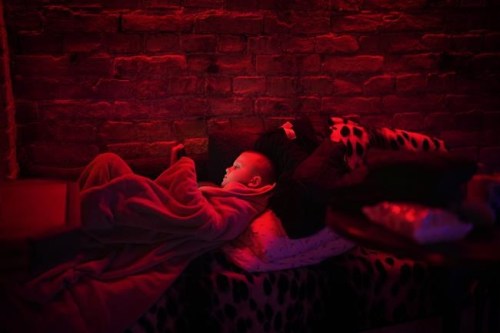 Svyatoslav, 6, plays with his tablet in a public basement used as a bomb shelter in Kyiv, Ukraine, Thursday, Feb. 24, 2022. Russia has launched a full-scale invasion of Ukraine, unleashing airstrikes on cities and military bases and sending troops and tanks from multiple directions in a move that could rewrite the world's geopolitical landscape. (AP Photo/Emilio Morenatti)