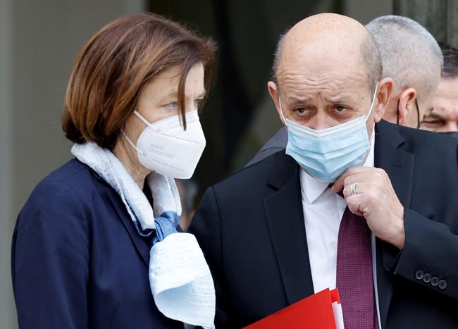 French Defence Minister Florence Parly, left, and French European and Foreign Affairs Minister Jean-Yves Le Drian talk after a security meeting on Ukraine at the Elysee Palace in Paris, Thursday, Feb. 24, 2022. Russian troops have launched a wide-ranging attack on Ukraine as President Vladimir Putin cast aside international condemnation and sanctions. (Ludovic Marin, Pool via AP)