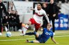 Stuttgart's Omar Marmoush, left, and Hoffenheim's Dennis Geiger battle for the ball during the Bundesliga soccer match between TSG 1899 Hoffenheim and VfB Stuttgart at the PreZero Arena, Sinsheim, Germany, Friday Feb. 25, 2022. (Uwe Anspach/dpa via AP)
