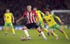 Southampton's Oriol Romeu and Norwich City's Josh Sargent, right, battle for the ball during the English Premier League soccer match at St. Mary's Stadium, in Southampton, England, Friday, Feb. 25, 2022. (Adam Davy/PA via AP)