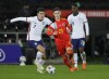 FILE - United States' Gio Reyna, left, vies for the ball with Wales' Dylan Levitt during the international friendly soccer match between Wales and USA at Liberty stadium in Swansea, Wales, Thursday, Nov. 12, 2020. Reyna is certain he’ll be fit again in time to help the United States qualify for the World Cup. The Americans have a final round of qualifiers against Mexico, Panama and Costa Rico next month and Reyna said Friday, Feb. 25, 2022, he is “pretty positive” he’ll be there with the team, too. (AP Photo/Kirsty Wigglesworth, File)
