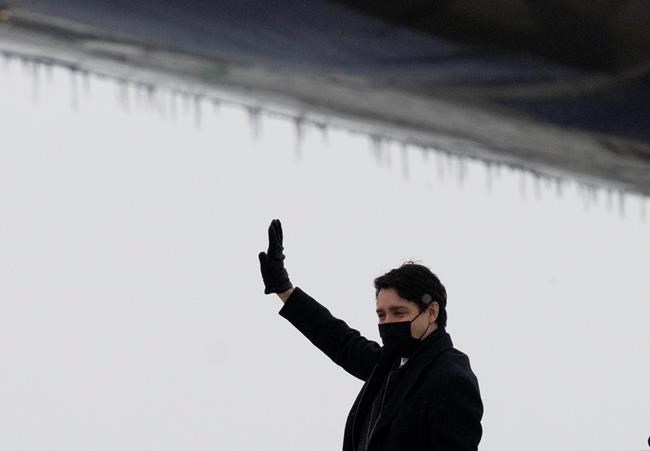 Canadian Prime Minister Justin Trudeau waves as he boards a government plane before departing for Europe, in Ottawa, Sunday, March 6, 2022. Trudeau is to meet with the leaders of the United Kingdom and the Netherlands today to discuss Russia's military invasion of Ukraine. THE CANADIAN PRESS/Adrian Wyld