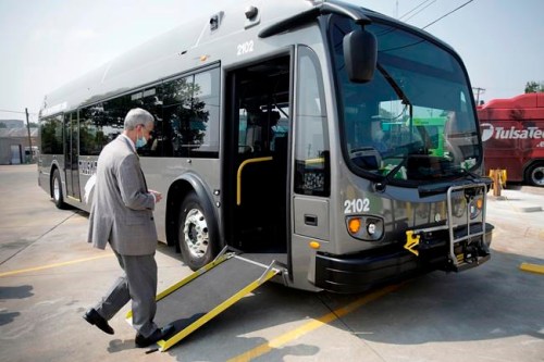 FILE - Tulsa Transit General Manager Ted Rieck boards a new electric bus on Aug. 3, 2021 in Tulsa, Okla. Tulsa Transit has 4 new electric buses in their fleet. Public transit systems straining to win back riders after crushing waves of the COVID-19 pandemic are getting a $3 billion boost to stay afloat and invest in electric buses. It's part of several initiatives being announced by the Biden administration March 7, 2022, to promote green-friendly mass transit as workers begin returning to offices (Mike Simons/Tulsa World via AP, File)