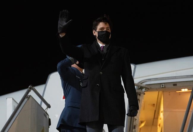 Prime Minister Justin Trudeau waves as he steps off a government plane after arriving in Riga, Latvia, Monday, March 7, 2022. THE CANADIAN PRESS/Adrian Wyld