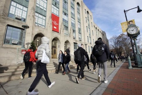 FILE - In this Thursday, Nov. 29, 2018, photo students and passers-by walk past an entrance to Boston University College of Arts and Sciences in Boston. Graduating from college brings with it a lot of change, and that might mean a shift in your financial situation. With just a couple of months before another class leaves college behind, now is the time to start prepping your money to make the transition a little bit easier. (AP Photo/Steven Senne, File)