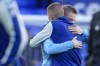 Manchester City's Oleksandr Zinchenko of Ukraine, left, hugs Everton's Vitaliy Mykolenko of Ukraine before the English Premier League soccer match between Everton and Manchester City at Goodison Park in Liverpool, England, Saturday, Feb. 26, 2022. (AP Photo/Jon Super)