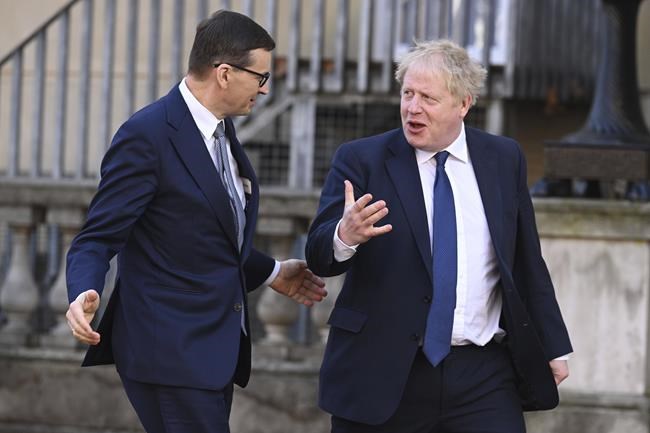 Britain's Prime Minister Boris Johnson, right, walks withPoland's Prime Minister Mateusz Morawiecki ahead of a plenary session of the Visegrad Four or V4 and UK, at Lancaster House, in London, Tuesday, March 8, 2022. The Prime Ministers of UK, Poland, Slovakia, Czech Republic and Hungary met in London to discuss European security, Ukraine and the looming energy crisis. (Leon Neal/Pool Photo via AP)