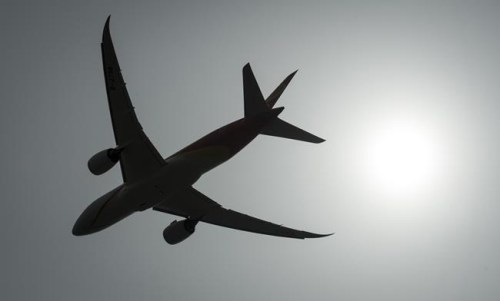 A plane is silhouetted as it takes off from Vancouver International Airport in Richmond, B.C., Monday, May 13, 2019.&nbsp; Pilots say a Transport Canada backlog is holding up medical certification, leading to months-long delays before they can return to the skies.THE CANADIAN PRESS/Jonathan Hayward