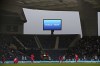 Video screens and publicity boards show the word 