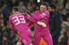 Manchester City's goalkeeper Scott Carson, left, replaces Manchester City's goalkeeper Ederson during the Champions League round of 16 second leg soccer match between Manchester City and Sporting Lisbon at the City of Manchester Stadium in Manchester, England, Wednesday, March 9, 2022. (AP Photo/Dave Thompson)