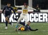 New England Revolution midfielder Arnor Ingvi Traustason, slides to challenge Pumas defender Alan Mozo (2) for the ball as New England Revolution forward Gustavo Bou (7) looks on during the first half of a CONCACAF Champions League soccer match Wednesday, March 9, 2022, in Foxborough, Mass. (AP Photo/Mary Schwalm)