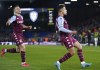 Aston Villa's Philippe Coutinho, right, celebrates scoring their side's first goal of the game during their English Premier League soccer match against Leeds United at Elland Road, Leeds, England, Thursday, March 10, 2022. (Tim Goode/PA via AP)