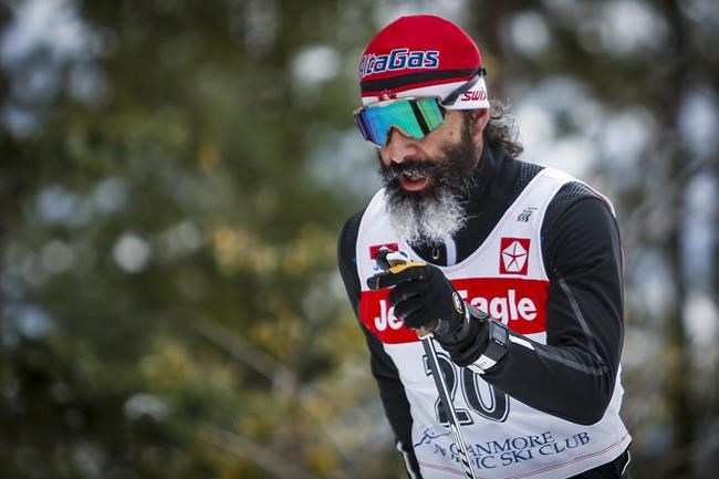 Canadian Cross-Country Ski Team member Brian McKeever skis up a hill during early season training in Canmore, Alta., Monday, Oct. 19, 2020. McKeever of Canmore, Alta., along with guide Graham Nishikawa, won gold in the men's para cross-country middle distance vision impaired race at the 2022 Winter Paralympics. THE CANADIAN PRESS/Jeff McIntosh