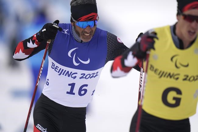 Canada's Brian McKeever and his guide Graham Nishikawa compete during the men's middle distance free technique vision impaired event of para cross country skiing at the 2022 Winter Paralympics in Zhangjiakou, China, Saturday, March 12, 2022. McKeever won his 16th Paralympic gold medal today. THE CANADAIN PRESS/AP-Shuji Kajiyama