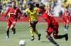 Columbus Crew defender Steven Moreira, center, dribbles the ball as Toronto FC forward Ifunanyachi Achara, right, defends during the first half of an MLS soccer match&nbsp;in Columbus, Ohio, Saturday, March 12, 2022. THE CANADIAN PRESS/AP-Joe Maiorana