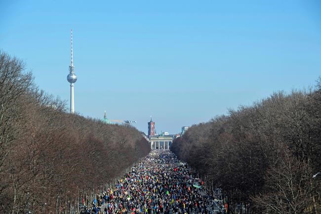 People attend rally against the Russian invasion on Ukraine in Berlin, Germany, Sunday, March 13, 2022. On Thursday, Feb. 24, 2022 Russian troops have launched their anticipated attack on Ukraine. (Paul Zinken/dpa via AP)