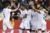 Real Madrid players celebrate after Vinicius Junior, 4th left, scored the opening goal during a Spanish La Liga soccer match between Mallorca and Real Madrid in Palma de Mallorca, Spain, Monday, March 14, 2022. (AP Photo/Francisco Ubilla)