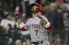FILE - Cincinnati Reds' Eugenio Suarez (7) celebrates at home plate after hitting a solo home run during the fifth inning of a baseball game against the Chicago White Sox, Tuesday, Sept. 28, 2021, in Chicago. In a deal announced Monday, March 14, 2022, the Seattle Mariners have acquired All-Star outfielder Jesse Winker and third baseman Eugenio Suárez from the Cincinnati Reds in exchange for a package of players. (AP Photo/Paul Beaty, File)
