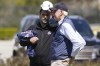 Atlanta Braves general manager, Alex Anthopoulos, left, speaks to Chairman and CEO Terry McGuirk at the CoolToday Park during spring training, Monday, March 14, 2022, in North Port, Fla. The Braves traded for first baseman Matt Olson of Oakland. (AP Photo/Steve Helber)