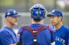Pitching coach Pete Walker, left, catcher Casey Janssen, centre, and pitcher Yusei Kikuchi chat after a bullpen session at a team workout at the Toronto Blue Jays Player Development Complex on, Tuesday, March 15, 2022, in Dunedin, Fla. THE CANADIAN PRESS/Mark Taylor