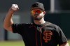 San Francisco Giants' Evan Longoria runs drills during spring training baseball workouts, Tuesday, March 15, 2022, in Scottsdale, Ariz. (AP Photo/Matt York)