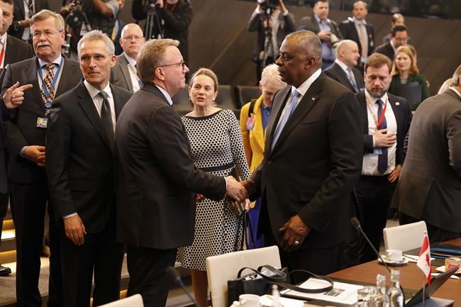 U.S. Secretary for Defense Lloyd J. Austin III, center right, speaks with Denmark's Defense Minister Trine Bramsen, center left, during a meeting of the North Atlantic Council in NATO defense ministers format at NATO headquarters in Brussels, Wednesday, March 16, 2022. NATO Secretary-General Jens Stoltenberg made it clear Tuesday that the 30-nation military alliance is set to radically change its security stance in Europe in response to Russia's war on Ukraine. (AP Photo/Olivier Matthys)