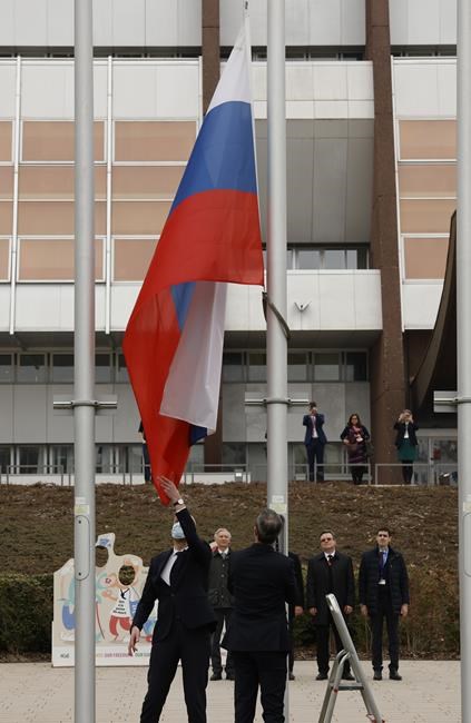 Employees of the Council of Europe remove the Russian flag from the Council of Europe building, Wednesday, March 16, 2022 in Strasbourg. The Council of Europe expelled Russia from the continent's foremost human rights body in an unprecedented move over its invasion and war in Ukraine. The 47-nation organization's committee of ministers said in statement that