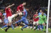 Manchester United's Harry Maguire, left, attempts shot at goal during the Champions League round of 16, second leg soccer match between Manchester United and Atletico Madrid at Old Trafford, Manchester, England, Tuesday, March 15, 2022. (AP Photo/Dave Thompson)