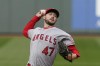 FILE - Los Angeles Angels starting pitcher Griffin Canning throws against the Seattle Mariners in the first inning of a baseball game Saturday, May 1, 2021, in Seattle. Canning won’t be ready for opening day after a setback in his recovery from a back injury. (AP Photo/Elaine Thompson, File)